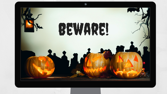 Desktop computer displaying Halloween scene with jack-o-lanterns with text "Beware!"