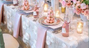 Elegant dining table setting with white and rose color scheme