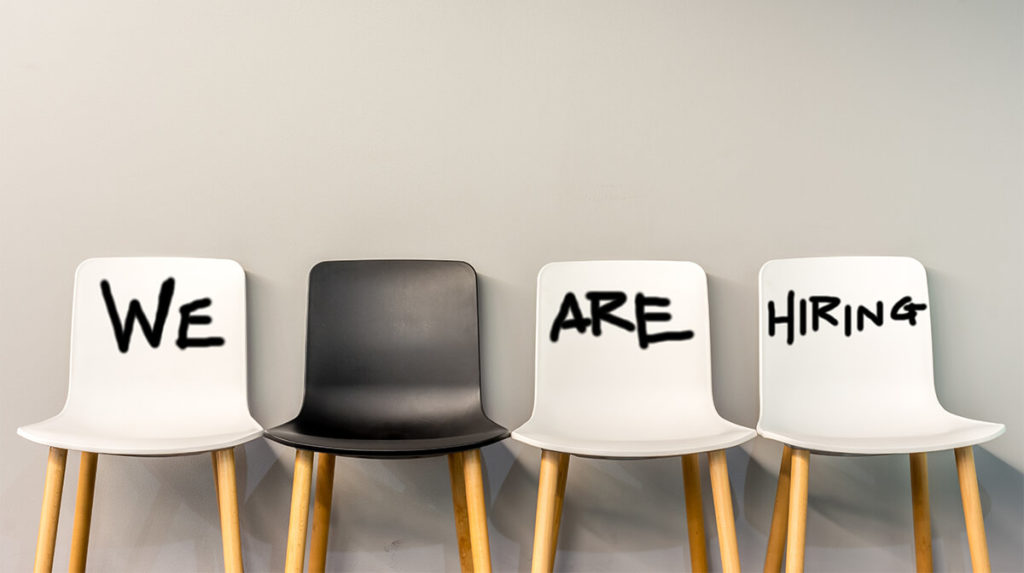 white and black chairs with text 'we are hiring' written on chair