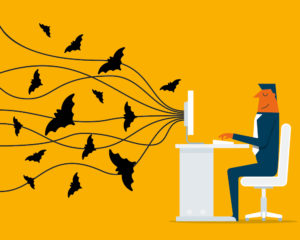 Person at Computer with Bats Flying Out